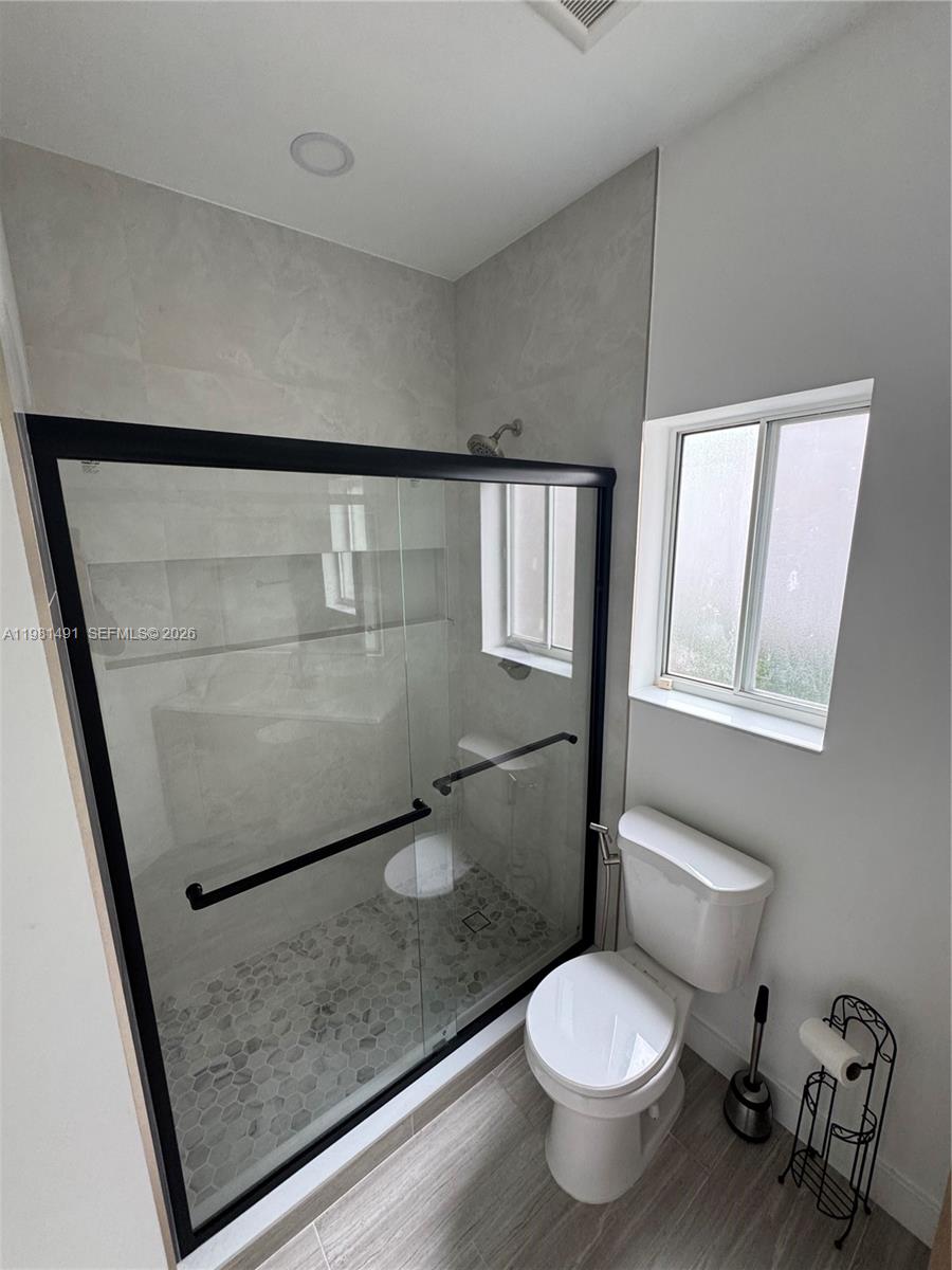 20478 Vía Marisa Boca Raton, FL 33498 - Photo 11 of 18 a bathroom with a toilet and a shower