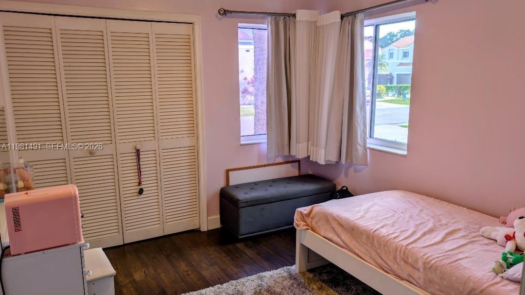 20478 Vía Marisa Boca Raton, FL 33498 - Photo 15 of 18 a bedroom with a bed and a window