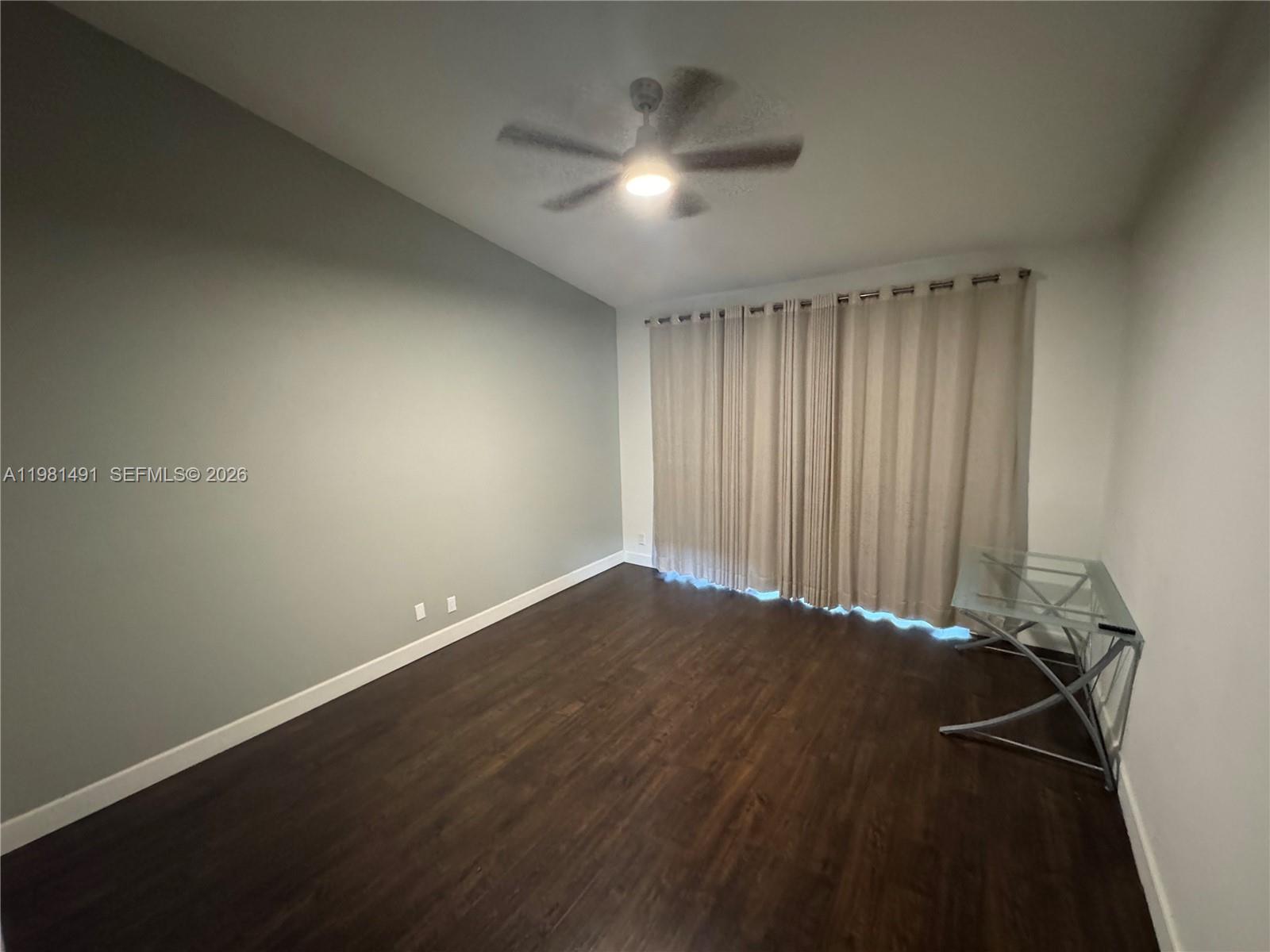 20478 Vía Marisa Boca Raton, FL 33498 - Photo 5 of 18 an empty room with a ceiling fan and window