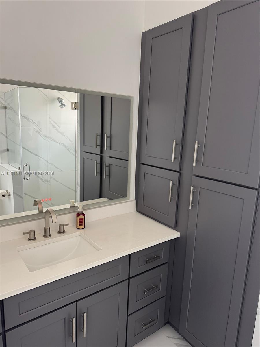 20478 Vía Marisa Boca Raton, FL 33498 - Photo 6 of 18 a bathroom with a sink and a large mirror