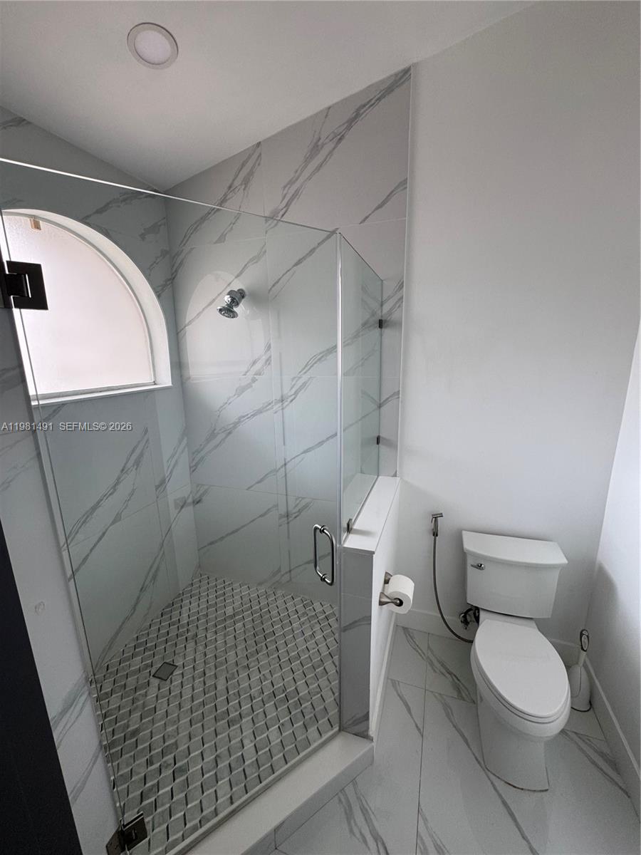20478 Vía Marisa Boca Raton, FL 33498 - Photo 7 of 18 a bathroom with a toilet and a shower