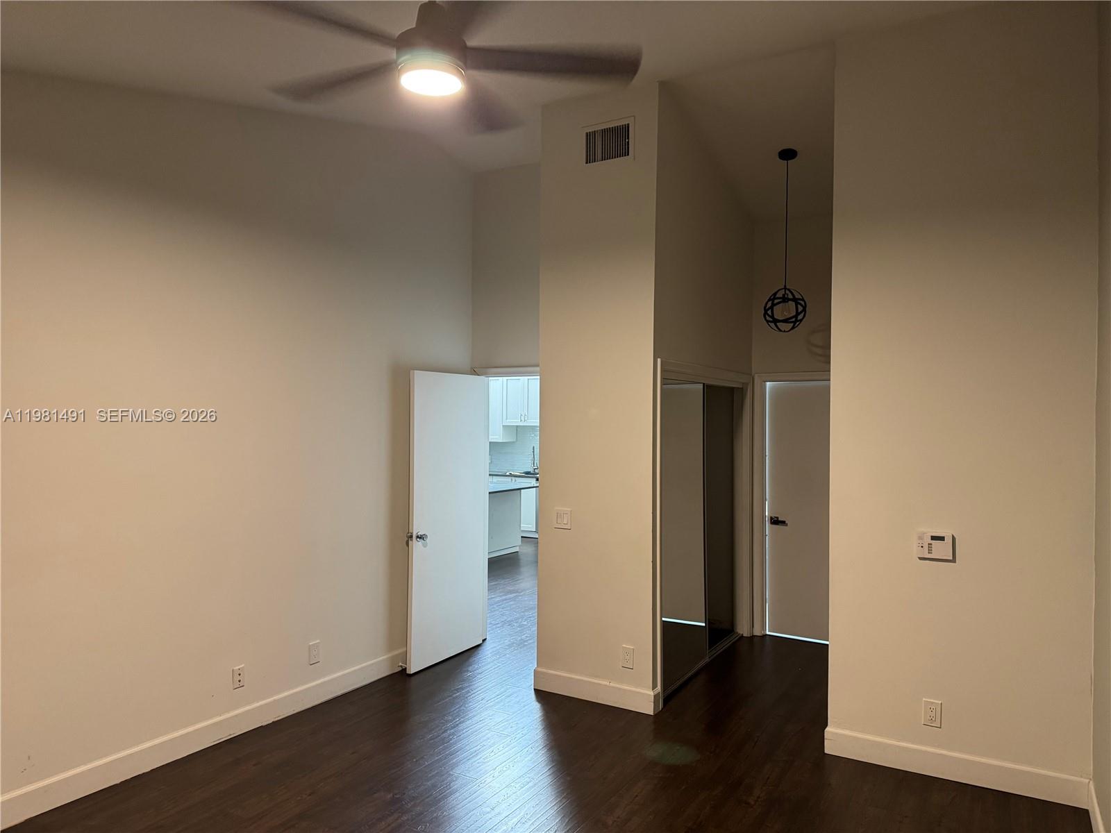 20478 Vía Marisa Boca Raton, FL 33498 - Photo 8 of 18 an empty room with wooden floor and windows
