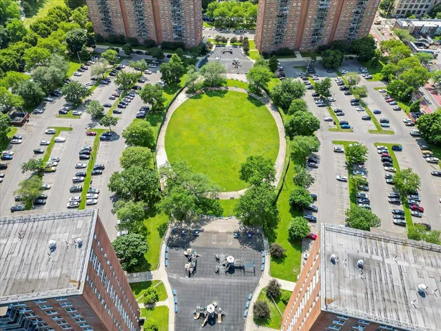 an aerial view of a residential houses with outdoor space and street view