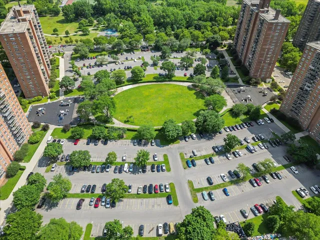 a view of a building with a garden and sitting area
