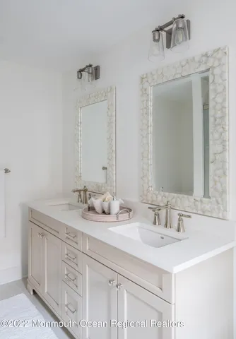 a bathroom with a sink double vanity and a mirror