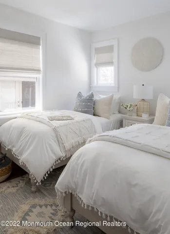 a bedroom with two beds and a window