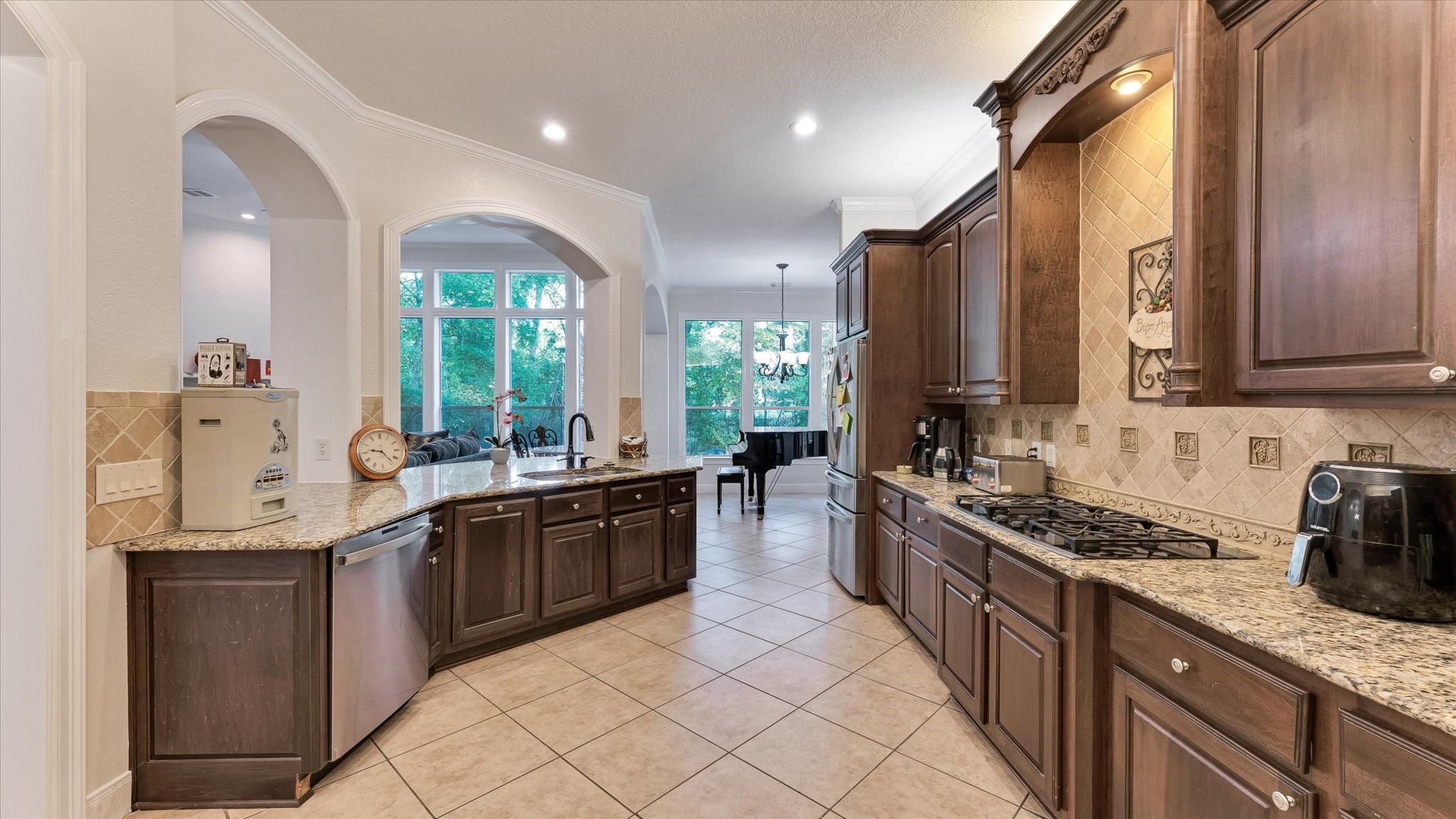 3 North Fair Manor Circle Spring, TX 77382 - Photo 15 of 39 a kitchen with stainless steel appliances granite countertop a stove a sink and a microwave