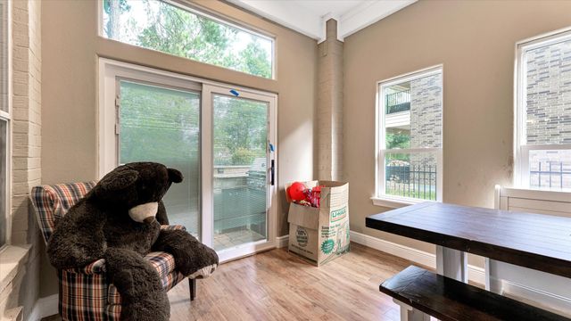 a view of kitchen with cabinets stainless steel appliances and a large window