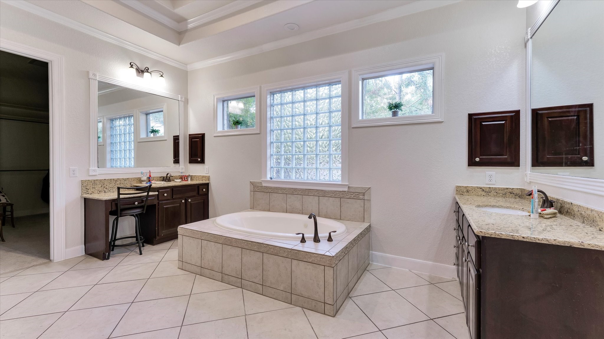 3 North Fair Manor Circle Spring, TX 77382 - Photo 23 of 39 a spacious bathroom with a tub double sink and mirror
