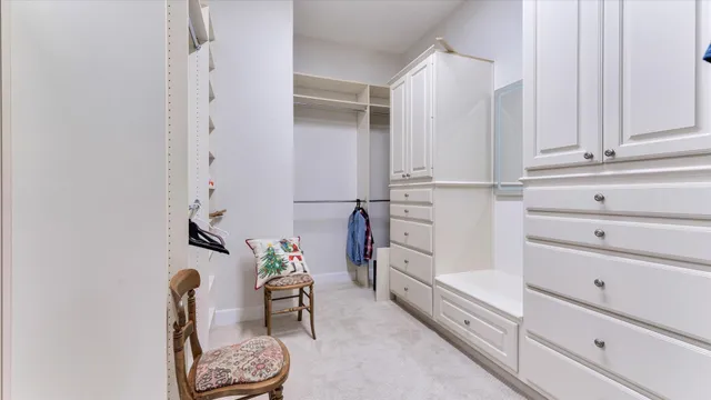 a view of walk in closet with clothes and shoes