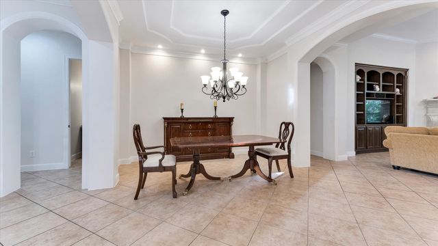 a view of a dining room with furniture and chandelier