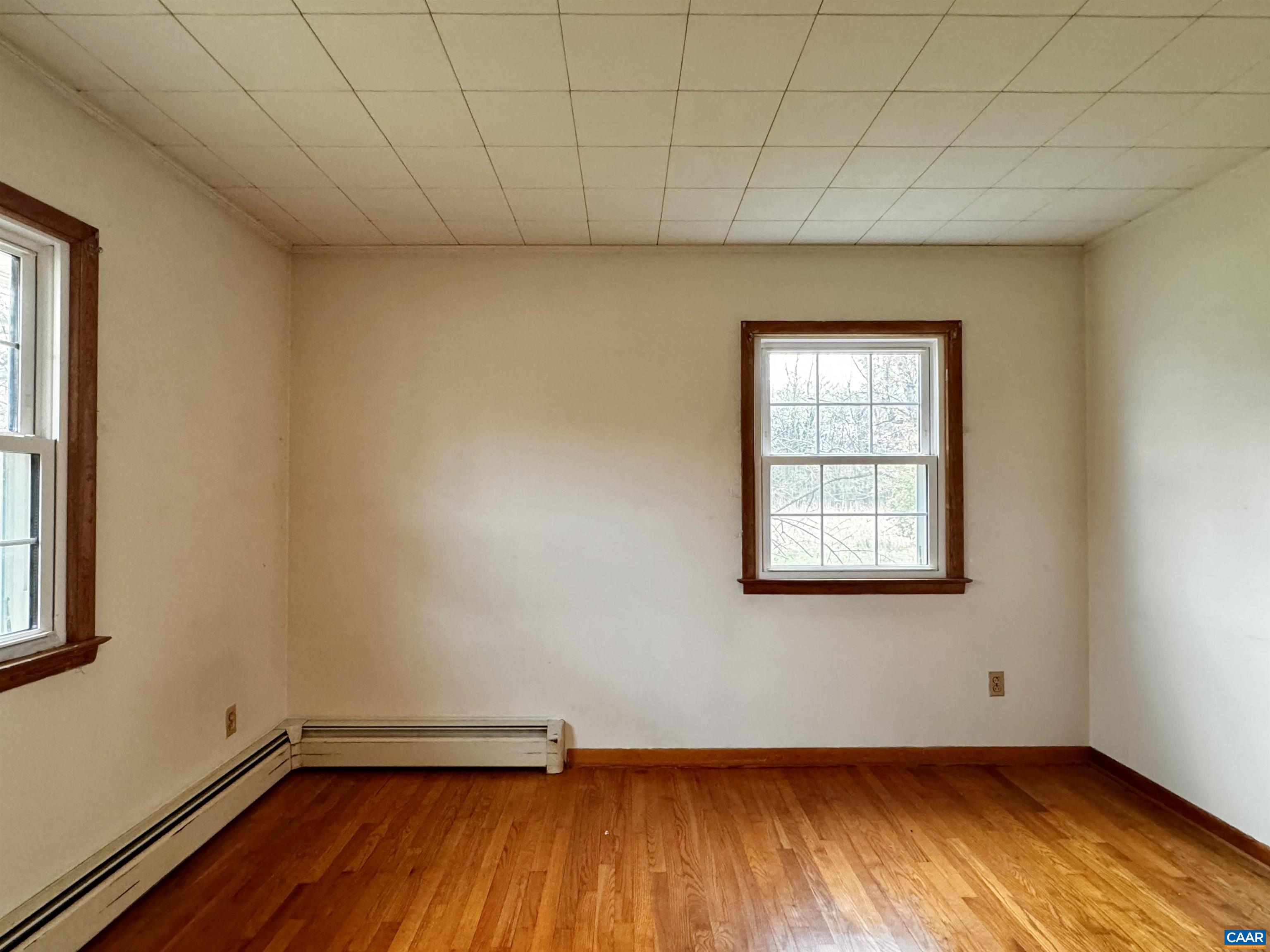 14540 Spotswood Trail Ruckersville, VA 22968 - Photo 12 of 42 an empty room with wooden floor and windows