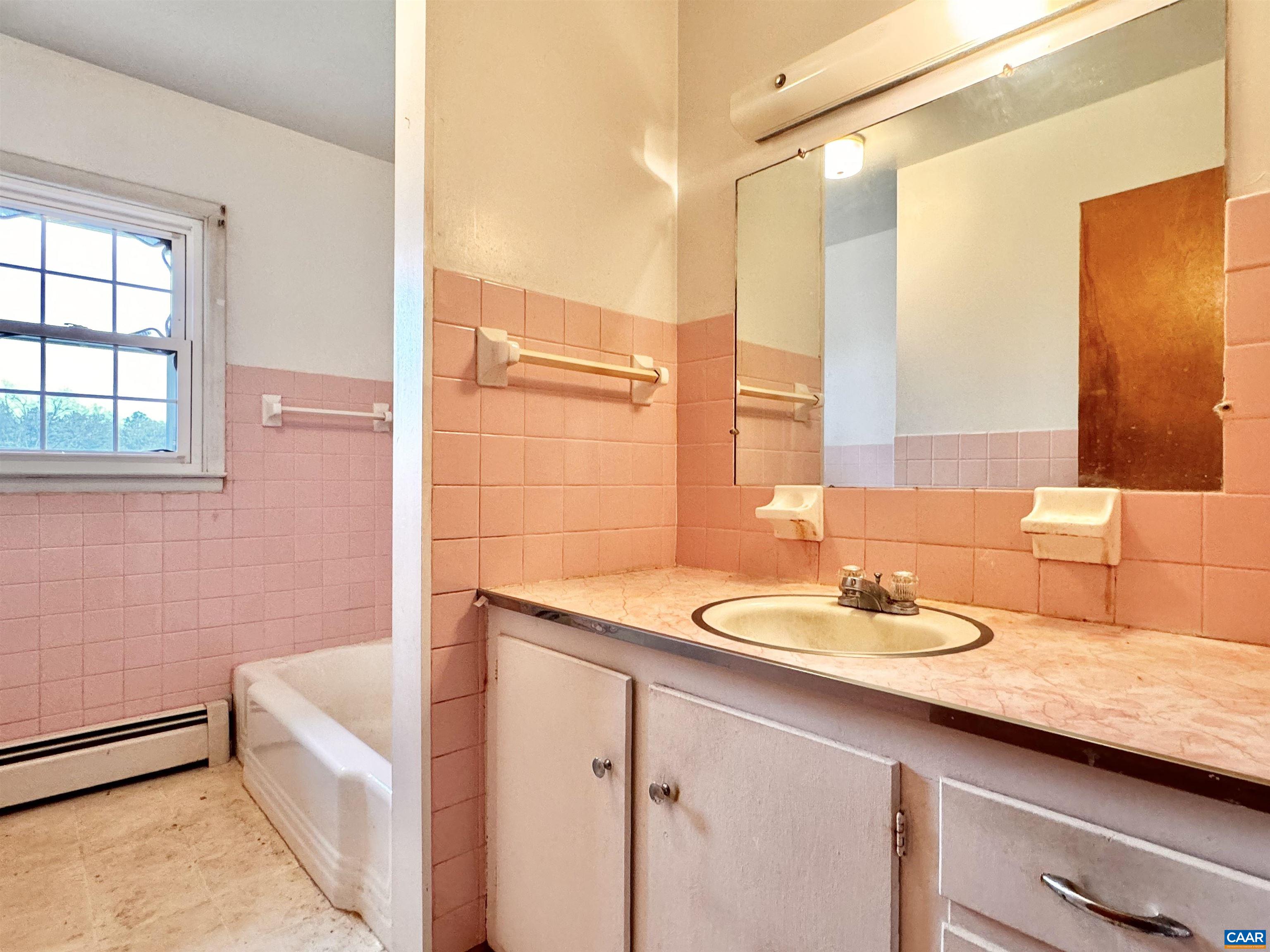 14540 Spotswood Trail Ruckersville, VA 22968 - Photo 14 of 42 a bathroom with a granite countertop sink and a large mirror