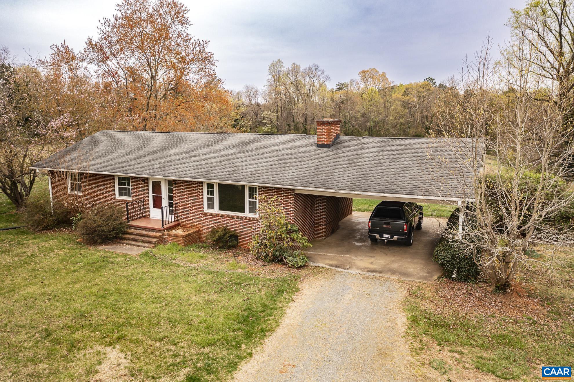 14540 Spotswood Trail Ruckersville, VA 22968 - Photo 40 of 42 a view of a house with a yard and trees in the background