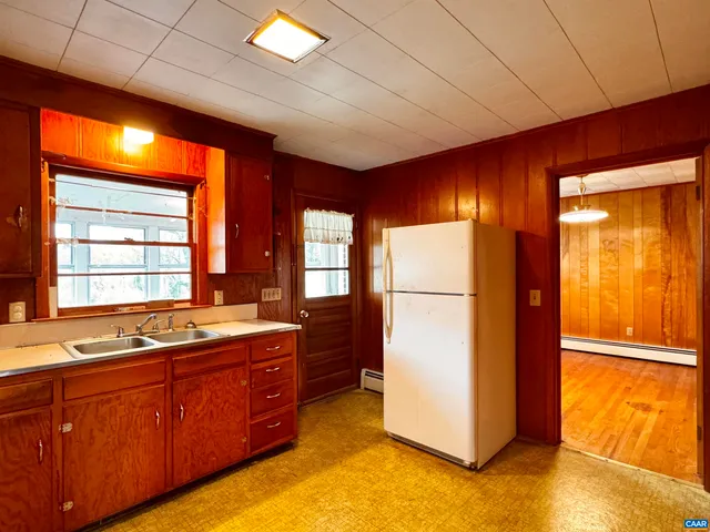 a kitchen with stainless steel appliances granite countertop a refrigerator a sink and dishwasher