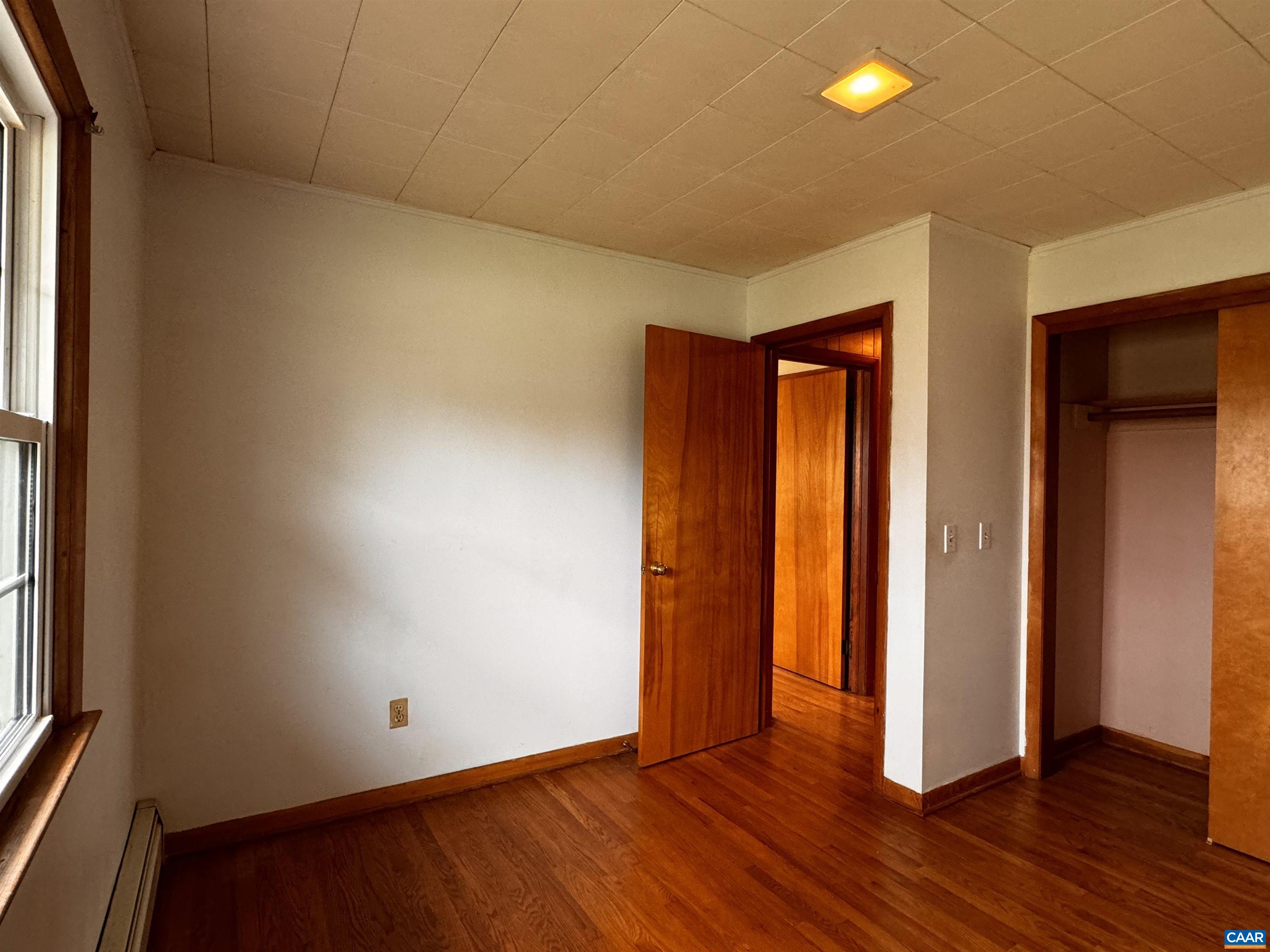 14540 Spotswood Trail Ruckersville, VA 22968 - Photo 8 of 42 an empty room with wooden floor and windows