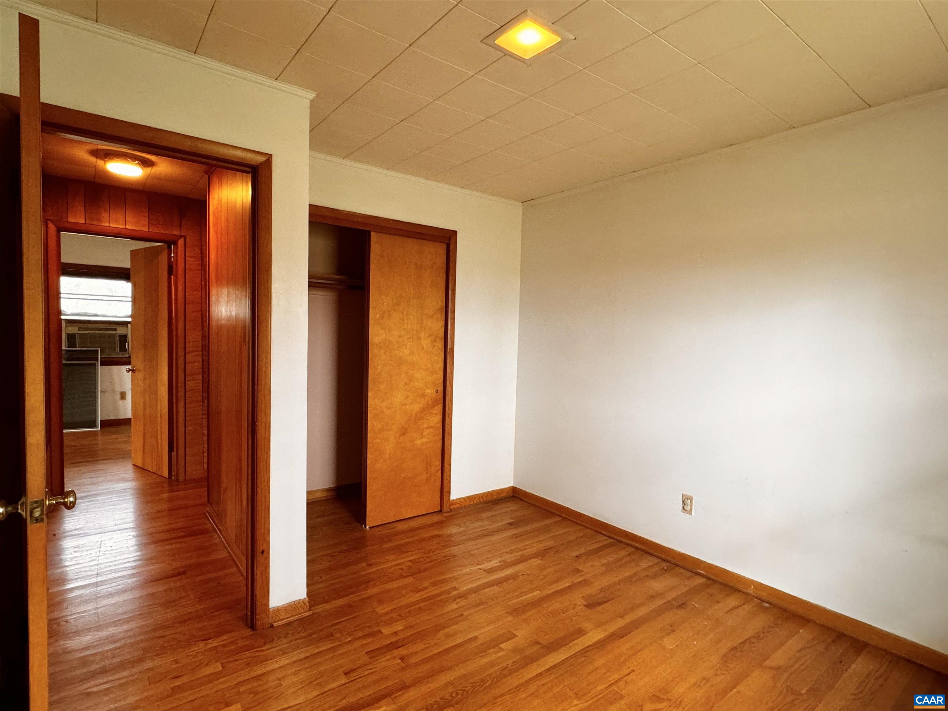 14540 Spotswood Trail Ruckersville, VA 22968 - Photo 10 of 42 a view of empty room with wooden floor and fan