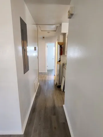 a view of hallway with wooden floor