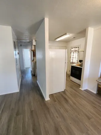 a view of a hallway view with wooden floor and staircase