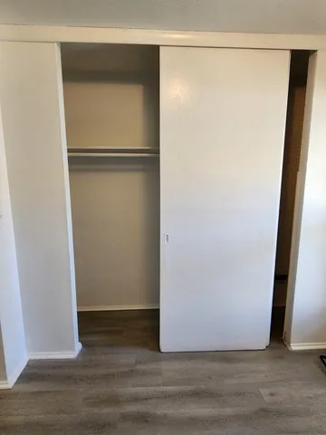 a view of a room with wooden floor