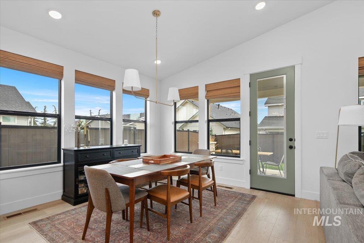 1911 East Mainacht Street Meridian, ID 83642 - Photo 19 of 49 Dining space with light wood-style flooring, recessed lighting, and vaulted ceiling