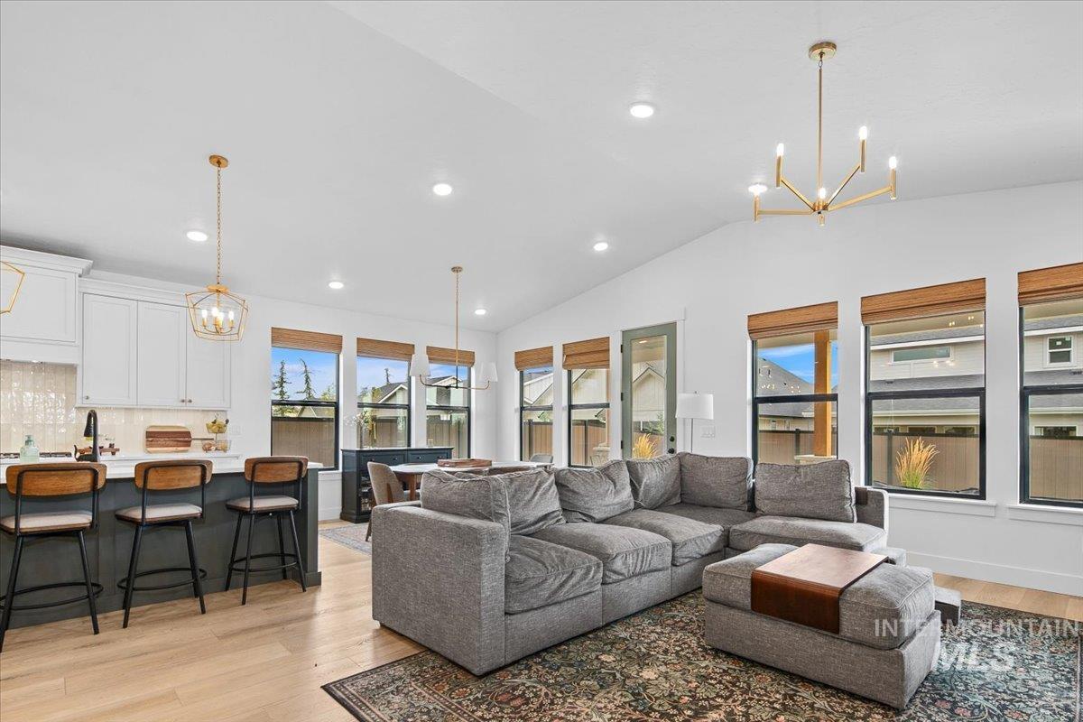 1911 East Mainacht Street Meridian, ID 83642 - Photo 22 of 49 Living room with a chandelier, light wood finished floors, lofted ceiling, and recessed lighting
