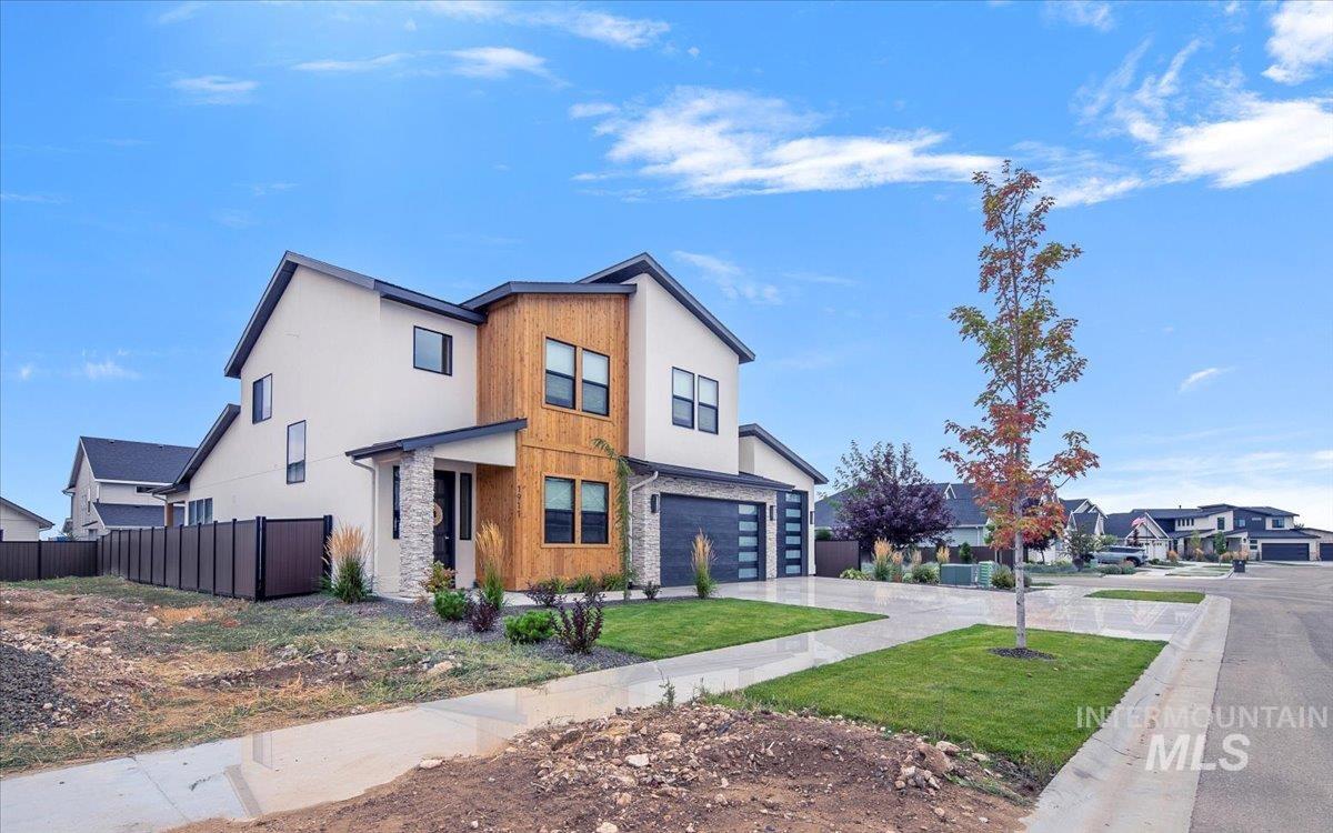 1911 East Mainacht Street Meridian, ID 83642 - Photo 3 of 49 Contemporary home with driveway, a residential view, stucco siding, and an attached garage