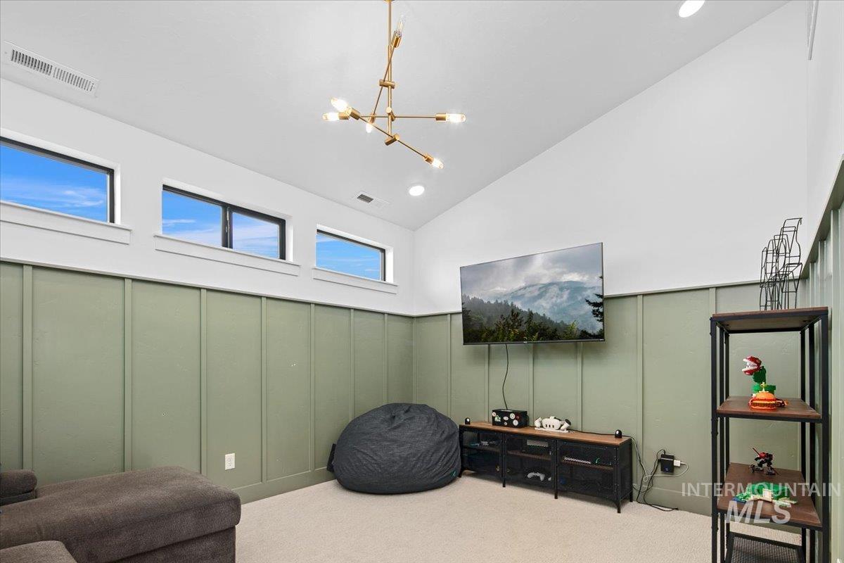 1911 East Mainacht Street Meridian, ID 83642 - Photo 37 of 49 Sitting room featuring a decorative wall, carpet, a chandelier, and high vaulted ceiling