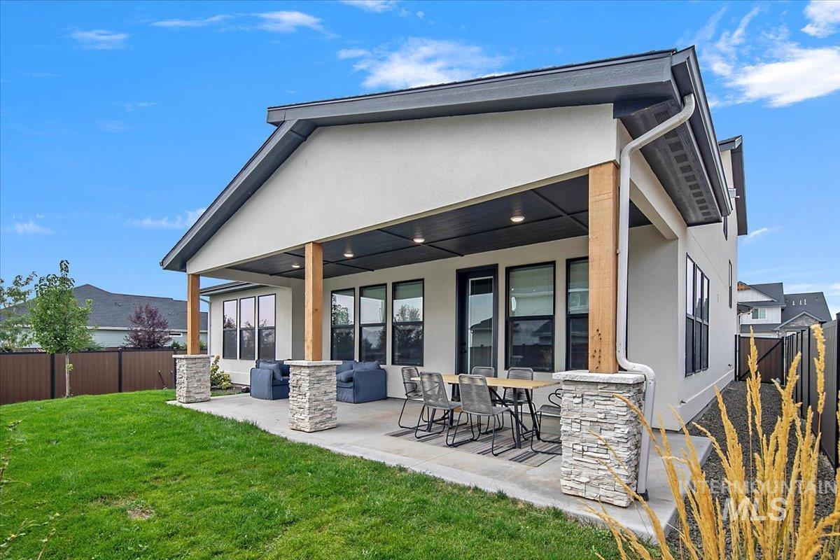 1911 East Mainacht Street Meridian, ID 83642 - Photo 46 of 49 Rear view of house featuring stucco siding, a fenced backyard, and a patio area