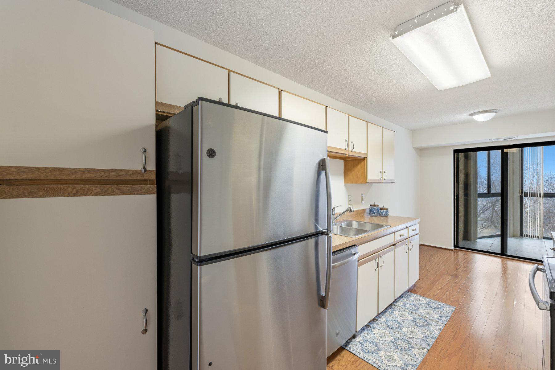 15107 Interlachen Drive, Unit 2801 Silver Spring, MD 20906 - Photo 17 of 50 a kitchen with stainless steel appliances a refrigerator sink and cabinets