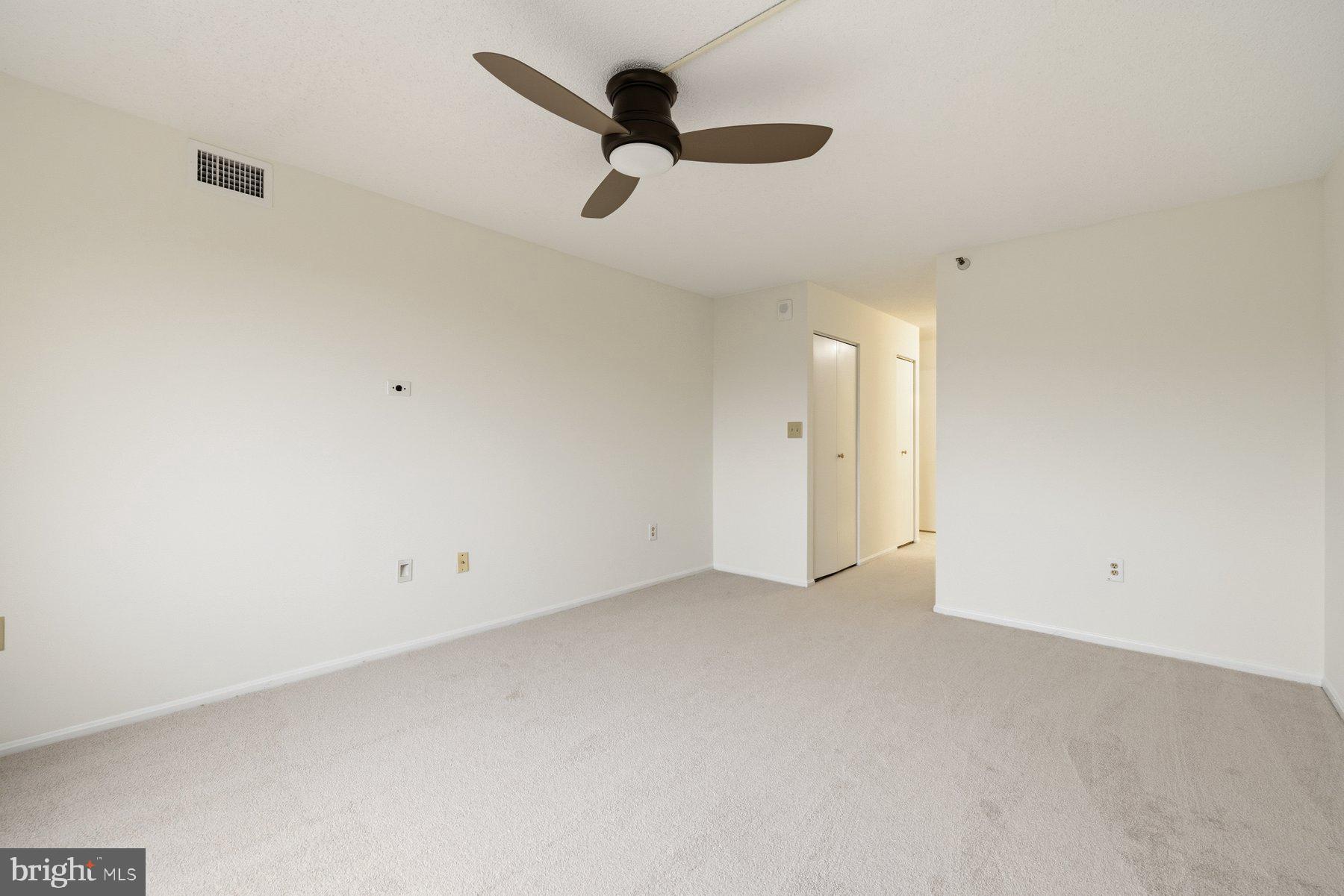 15107 Interlachen Drive, Unit 2801 Silver Spring, MD 20906 - Photo 24 of 50 an empty room with chandelier fan