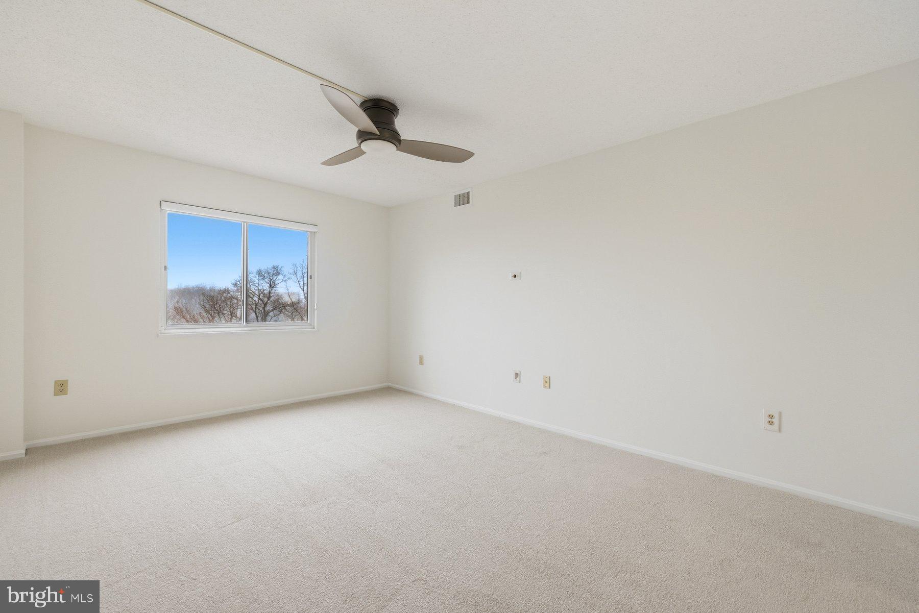 15107 Interlachen Drive, Unit 2801 Silver Spring, MD 20906 - Photo 25 of 50 a view of an empty room with a window