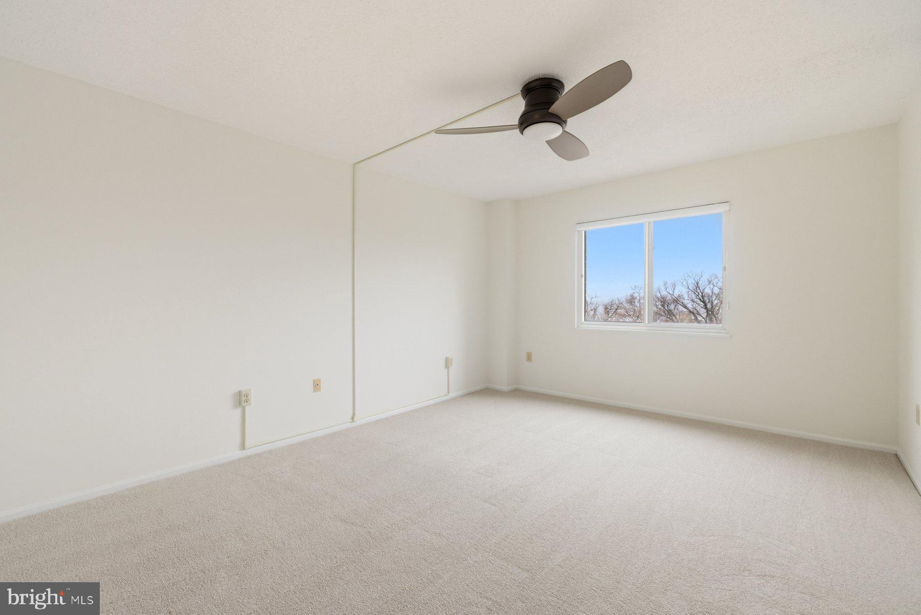 15107 Interlachen Drive, Unit 2801 Silver Spring, MD 20906 - Photo 26 of 50 a view of an empty room with a ceiling fan