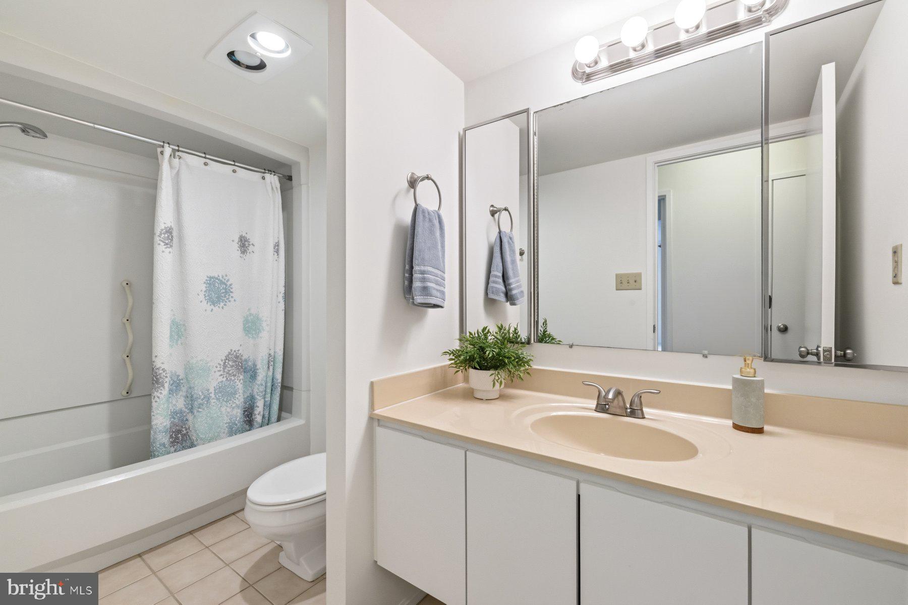 15107 Interlachen Drive, Unit 2801 Silver Spring, MD 20906 - Photo 35 of 50 a bathroom with a sink a toilet and shower