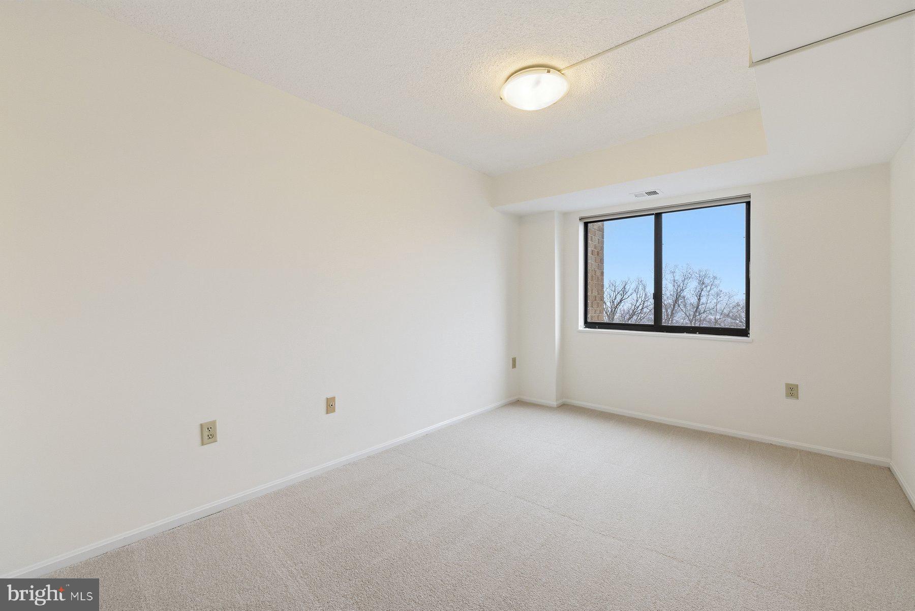 15107 Interlachen Drive, Unit 2801 Silver Spring, MD 20906 - Photo 38 of 50 an empty room with a window