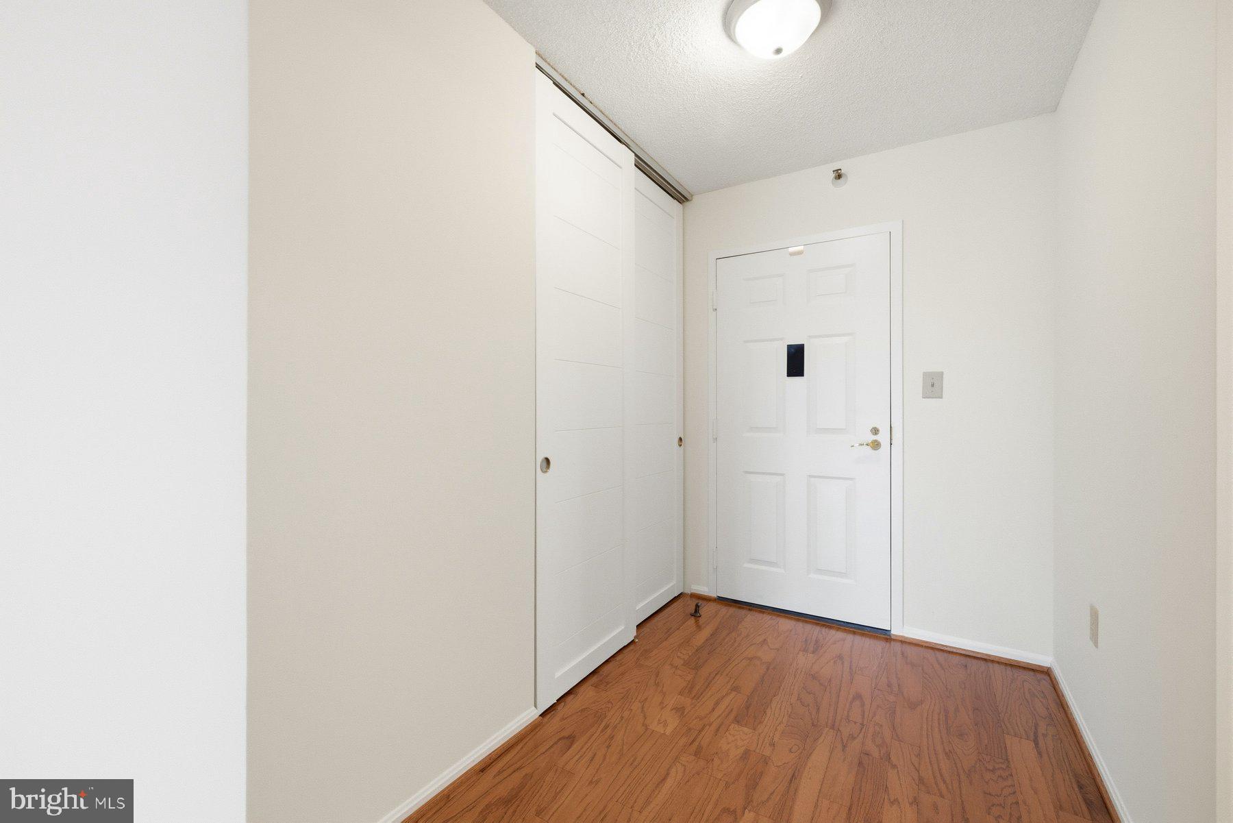 15107 Interlachen Drive, Unit 2801 Silver Spring, MD 20906 - Photo 4 of 50 a view of a hallway with wooden floor