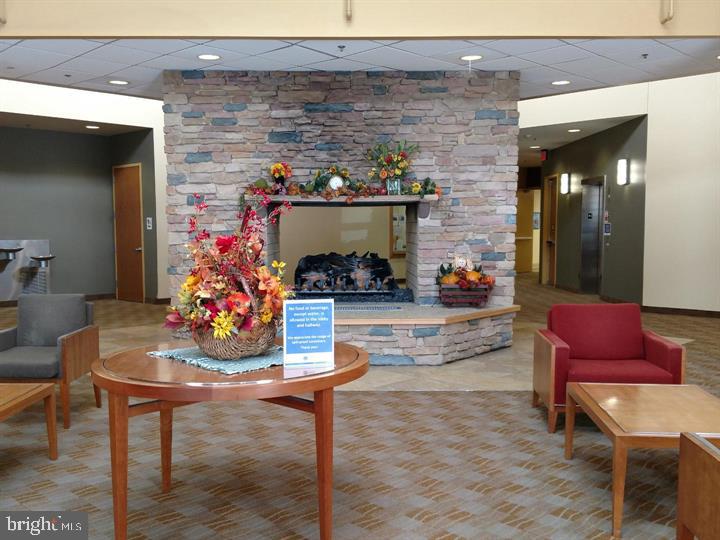 15107 Interlachen Drive, Unit 2801 Silver Spring, MD 20906 - Photo 46 of 50 a room with furniture and a table