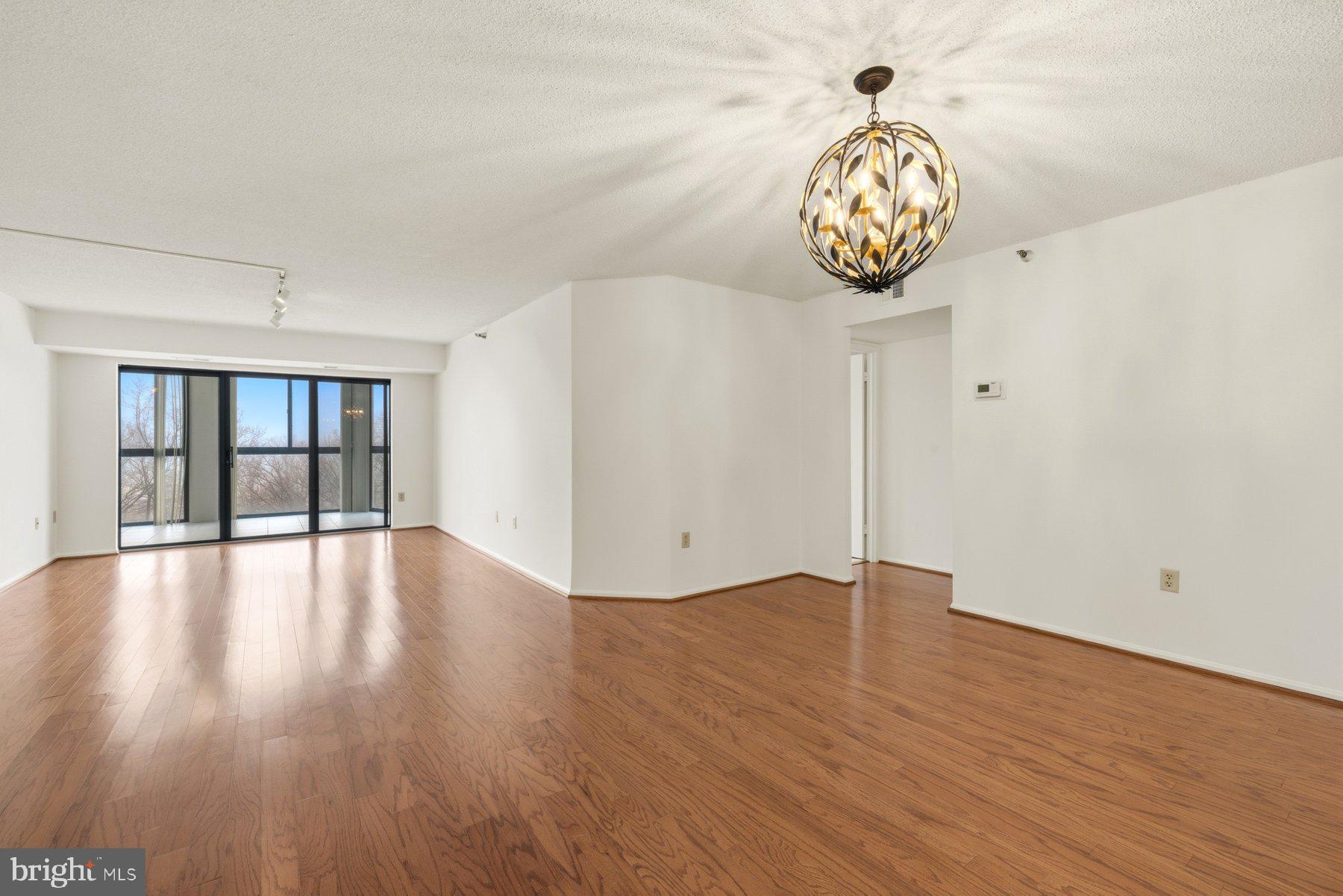 15107 Interlachen Drive, Unit 2801 Silver Spring, MD 20906 - Photo 10 of 50 a view of an empty room with wooden floor