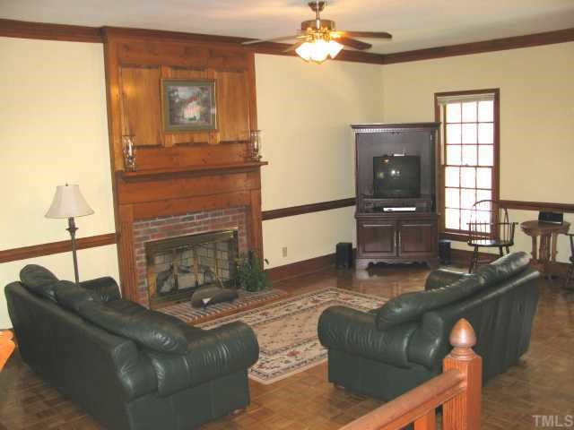 10604 Dunhill Terrace Raleigh, NC 27615 - Photo 4 of 12 Masonry Fireplace With Raised Panel Wood and Brick Surround in Family Room Den/Family/Great Room