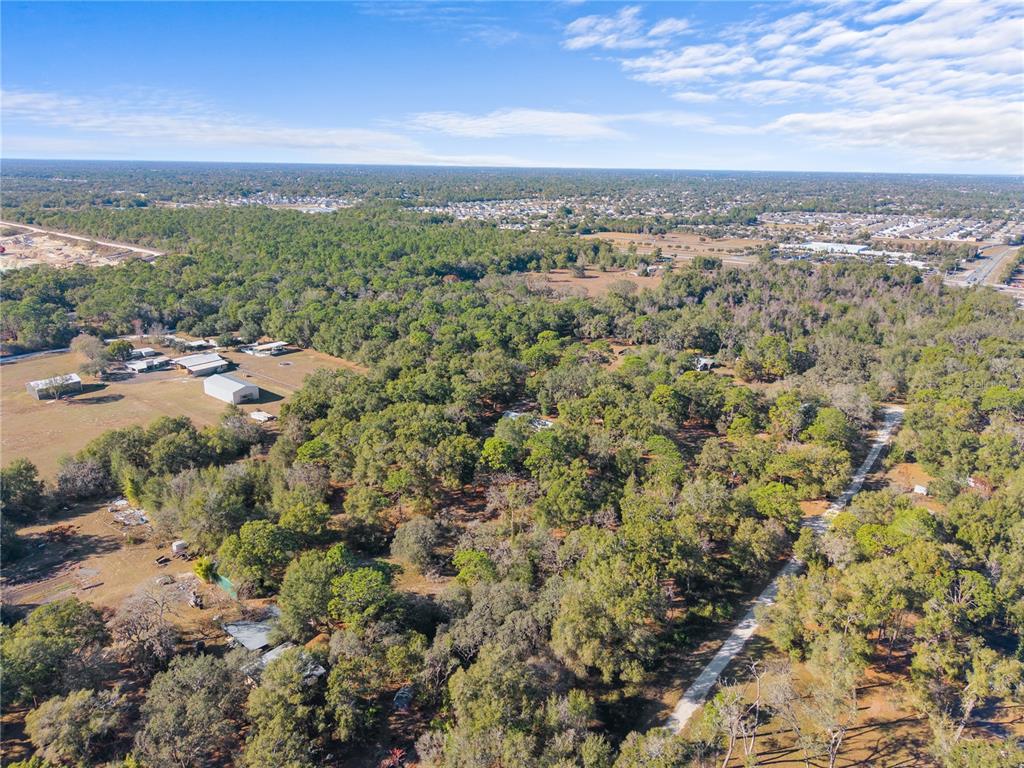 0 Deason Drive Spring Hill, FL 34610 - Photo 6 of 7 an aerial view of residential houses with outdoor space and trees