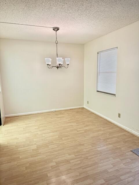 3063 Ainslie Drive Boca Raton, FL 33434 - Photo 4 of 33 a view of an empty room with a chandelier