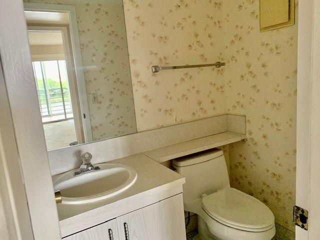 3063 Ainslie Drive Boca Raton, FL 33434 - Photo 10 of 33 a bathroom with a sink a toilet and shower