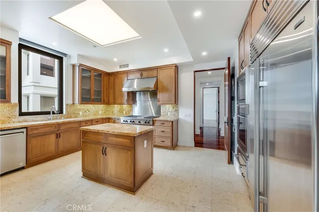 a kitchen with stainless steel appliances granite countertop a stove and a refrigerator