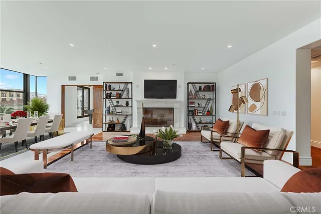 a living room with fireplace furniture and a wooden floor