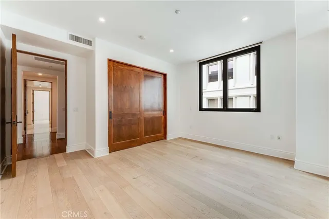 an empty room with windows and closet
