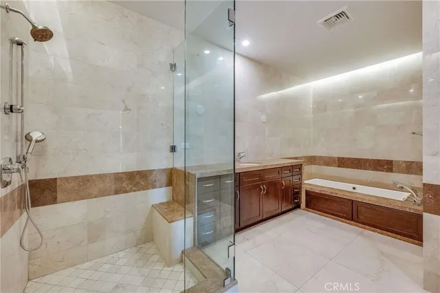 a bathroom with a tub a sink and a shower