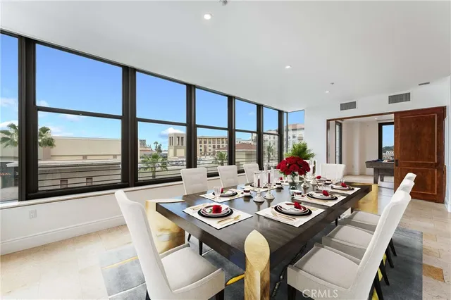 a dining room with furniture a large window and a table