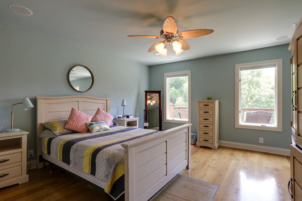 1100 Allen Road Murfreesboro, TN 37129 - Photo 22 of 30 a bedroom with a large bed and a chandelier