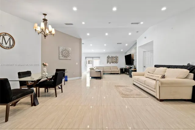 a living room with furniture a dining table and a fireplace
