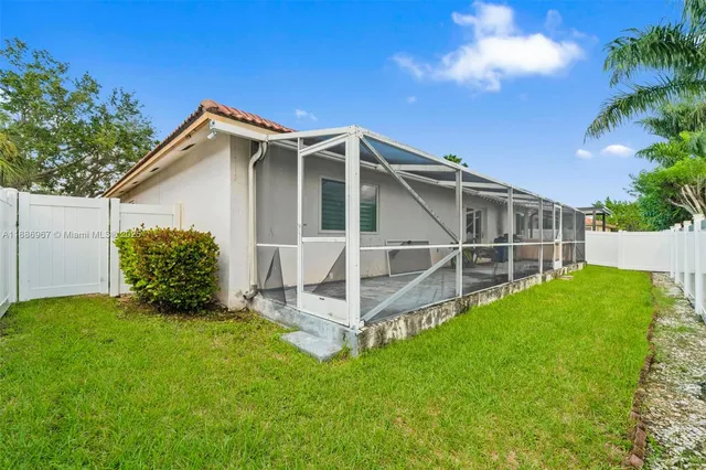 a view of a backyard with plants and a garden